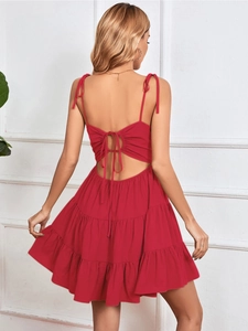 Detail of red backless mini dress showing tie-up back and tiered ruffle skirt