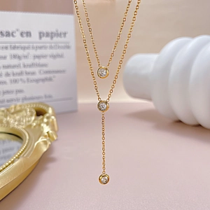 Detail of layered gold stainless steel necklace with sparkling cubic zirconia tassels