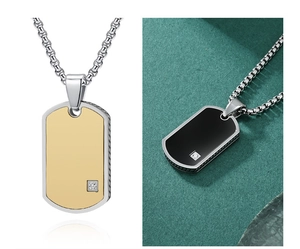 Detail of military dog tag pendants in gold and black with small diamond inlay