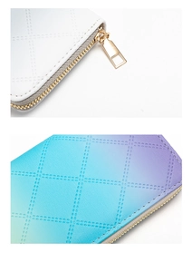 Detail of long PU leather wallets with perforated diamond pattern and gold metal zippers