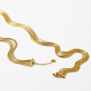 Elegant multi-strand gold fringe chain necklace with adjustable clasp on white background