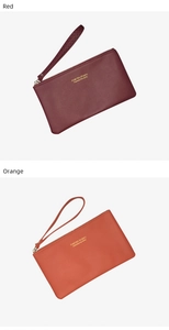 Detailed shot of red and orange leather wristlet wallets with gold zipper and wrist strap