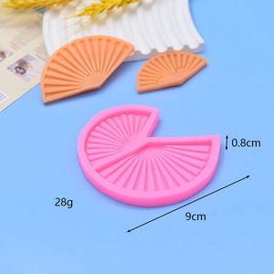 Pink fan-shaped silicone mold with orange DIY cake and soap finished products