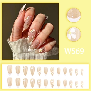 Faux ongles amande French avec motifs marguerites et base nude pailletée