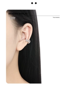 Detailed view of S925 sterling silver ear cuff with twisted lines and a sparkling zircon