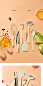 Close-up of cream silicone kitchen utensil set featuring whisk and spatula tools
