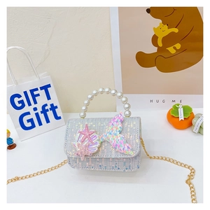 Detail of glitter girl handbag with sequin mermaid tail, starfish, and pearl handle