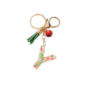 Christmas resin letter Y keychain with green tassel and red bell on white background