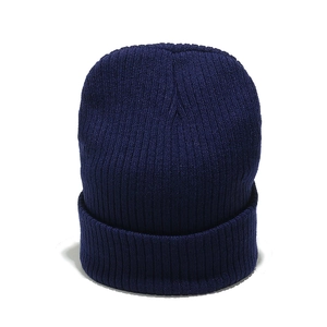 Close-up of dark blue rib-knit beanie showing soft texture and folded cuff detail