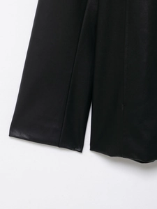 Close-up of the black coated leather jacket cuff showing detailed stitching and grain texture