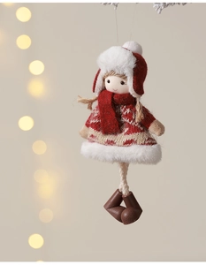 Detailed view of red plush Christmas girl doll with knitted sweater and winter hat decoration