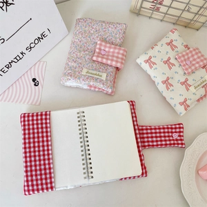 Bow fabric binder covers with floral and checkered patterns featuring heart snap buttons
