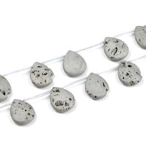 Macro detail of gray teardrop beads with metallic crystal texture on strings