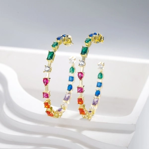 Chic gold hoop earrings featuring multi-color rainbow crystals on a white wavy base