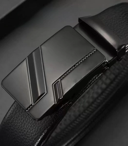 Detail of men's matte black automatic buckle belt with litchi grain leather texture