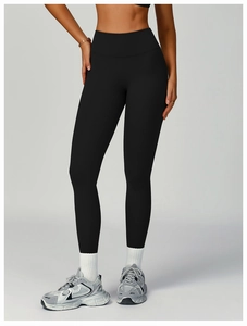 Close-up of black high-waist yoga leggings showing elastic compression and sculpting fit