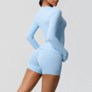 Detailed close-up of high-waist yoga shorts and long-sleeve top in sky blue matte fabric