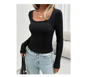 Detail of black ribbed knit long sleeve top with square neck and lace trim