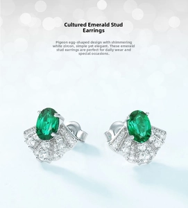 Macro detail of fan-shaped S925 silver earrings with emerald and shiny zircon accents