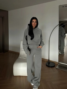 Women's grey two-piece tracksuit featuring a cropped hoodie and high-waisted sweatpants