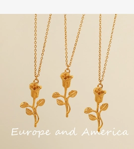 Detailed view of three vintage rose pendants on delicate gold chains with polished finish