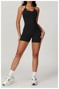 Close-up of black halter neck sports top and high-waisted shorts in breathable fabric