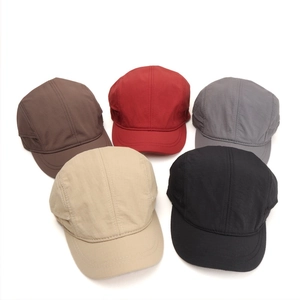 Flat lay of five-panel quick-dry baseball caps in brown, red, grey, beige and black