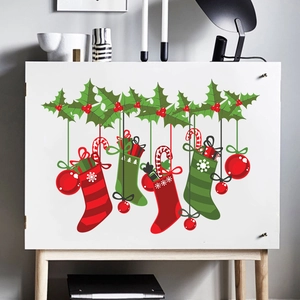 Detailed view of festive Christmas stocking wall stickers on a modern white cabinet door