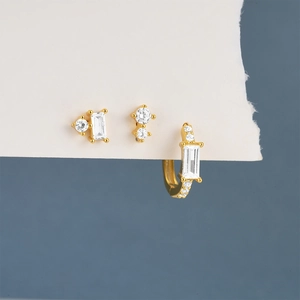 Macro view of gold S925 silver earrings set with zircon and rectangular cut stones
