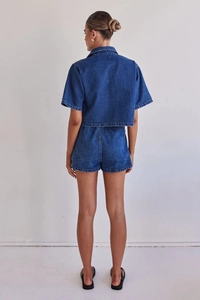 Rear view of denim cargo set featuring a short-sleeve shirt and high-waist shorts