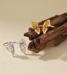 Detail of elegant butterfly open rings in gold and silver with zircon inlays
