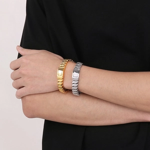 Modern twisted wave pattern curb chain bracelets in polished gold and silver finishes