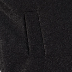Detail view of the fine texture and stitching on the black twill jacket pocket