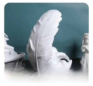 Close-up of white resin feather sculpture showing intricate texture and elegant craftsmanship
