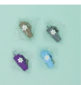 Detail of colorful mini cup keychains with straw and floral print in individual poly bags