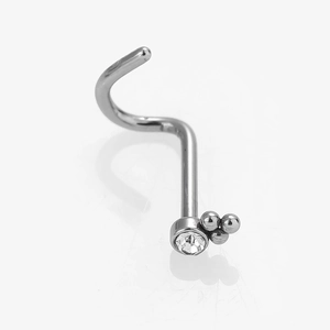 Macro shot of L-shaped stainless steel nose stud with clear zircon and three micro beads