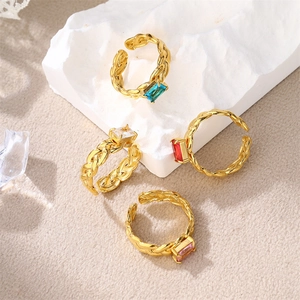 Detailed macro of gold plated stainless steel rings with colorful rectangle zircon stones