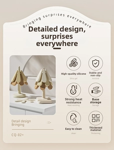 Detail of Christmas tree silicone trivet set with vertical storage stand in cream and brown