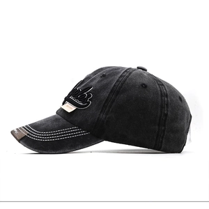 Detailed macro of vintage washed baseball cap with 3D embroidery and side label