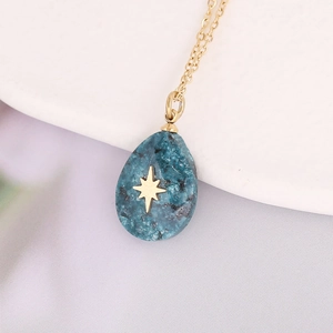 Gold stainless steel necklace featuring a teardrop blue stone pendant with a star design