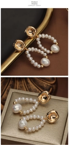 Detailed macro view of baroque pearl earrings with square gold metal drop design