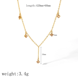 Detailed view of 18k gold Y-shaped necklace with five champagne square zircons
