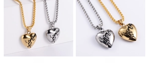 Detailed view of silver and gold stitched broken heart pendants on box chains