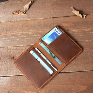 Internal card slots of the vintage brown crazy horse leather wallet on a wooden table