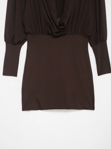 Detail of deep brown long sleeve mini dress with a draped V-neck and cinched waist
