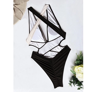 Detail of cross-strapped back on black and white one-piece swimsuit with ruching