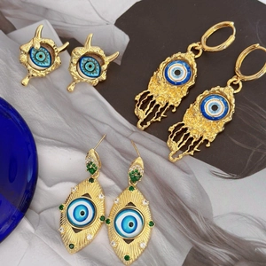 Vintage gold Evil Eye earrings set with blue accents and bohemian textured metal details