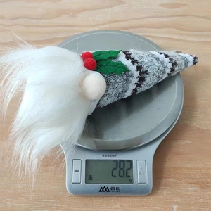 Close-up of weight measurement for a handmade Christmas gnome hanging decoration, 28.2g