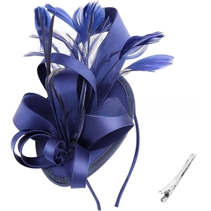 Macro detail of navy blue fascinator showing satin ribbon bow and natural feather texture