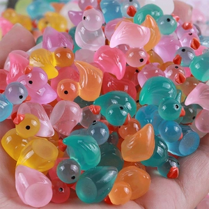 Close-up of colorful luminous resin mini ducks for DIY crafts and micro landscape decor